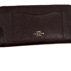 Brown leather Coach zippy wallet.